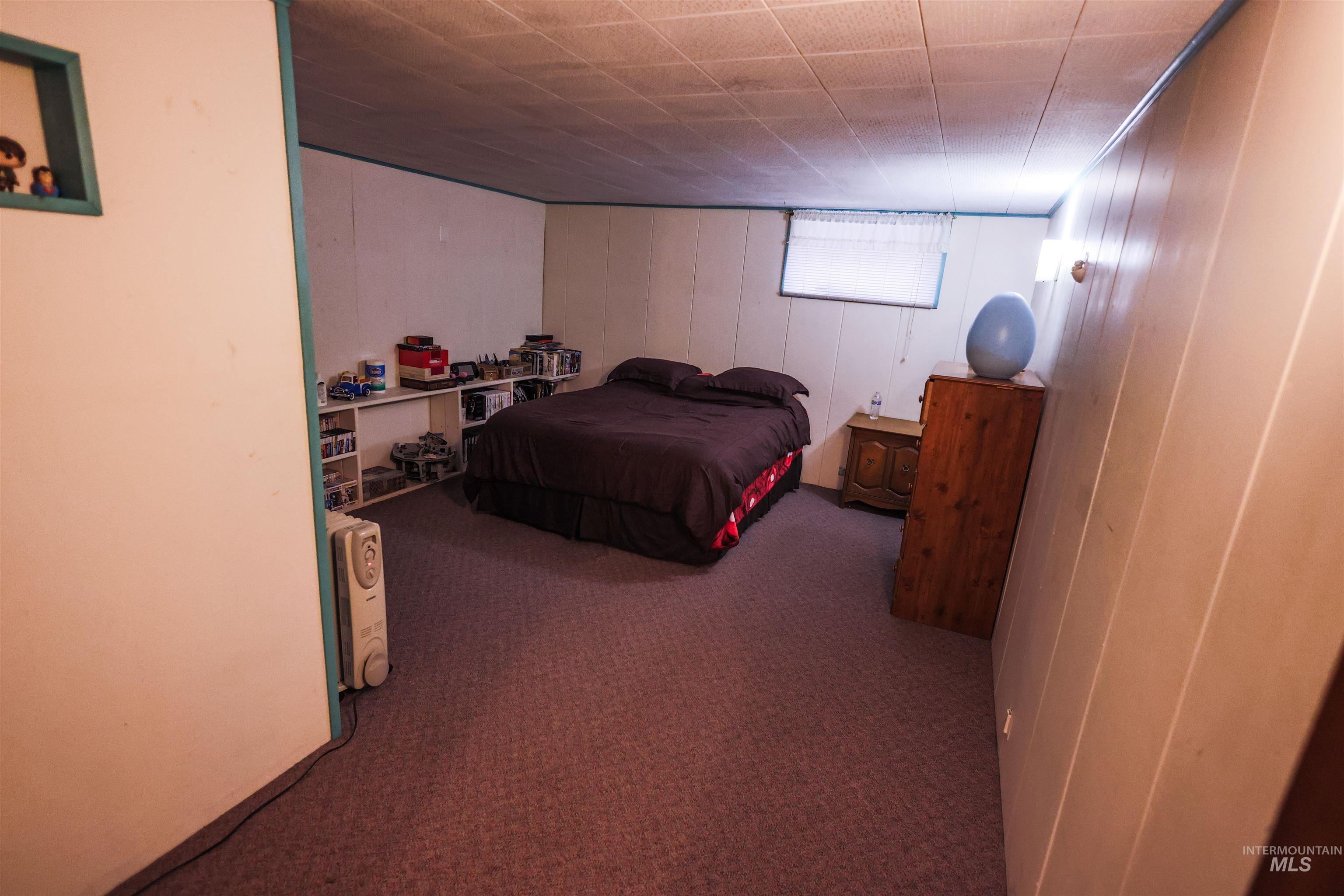 712 Hill Street Kamiah, ID 83536 - Photo 32 of 41 Carpeted bedroom featuring wooden walls