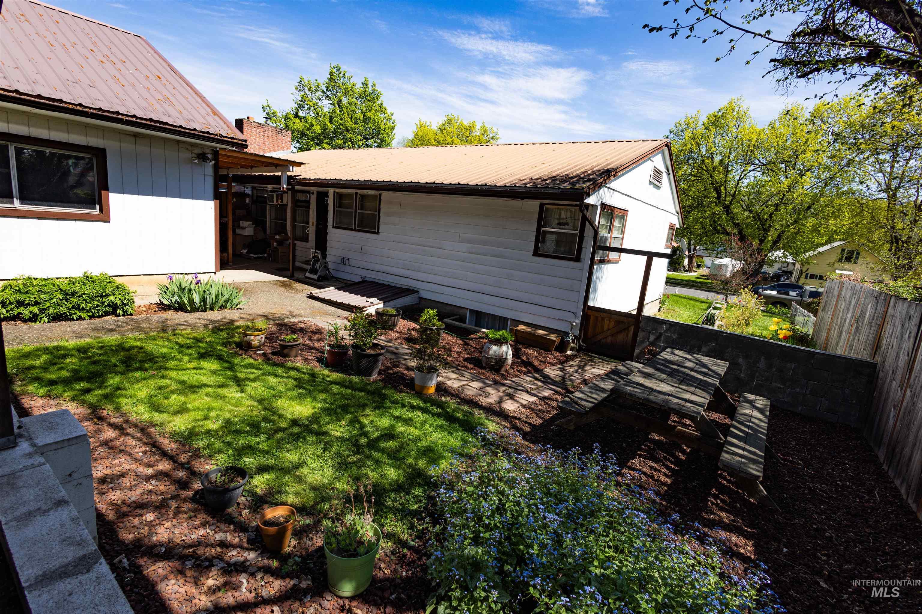 712 Hill Street Kamiah, ID 83536 - Photo 9 of 41 Expansive backyard featuring a tiered design with a lawn area and a concrete patio