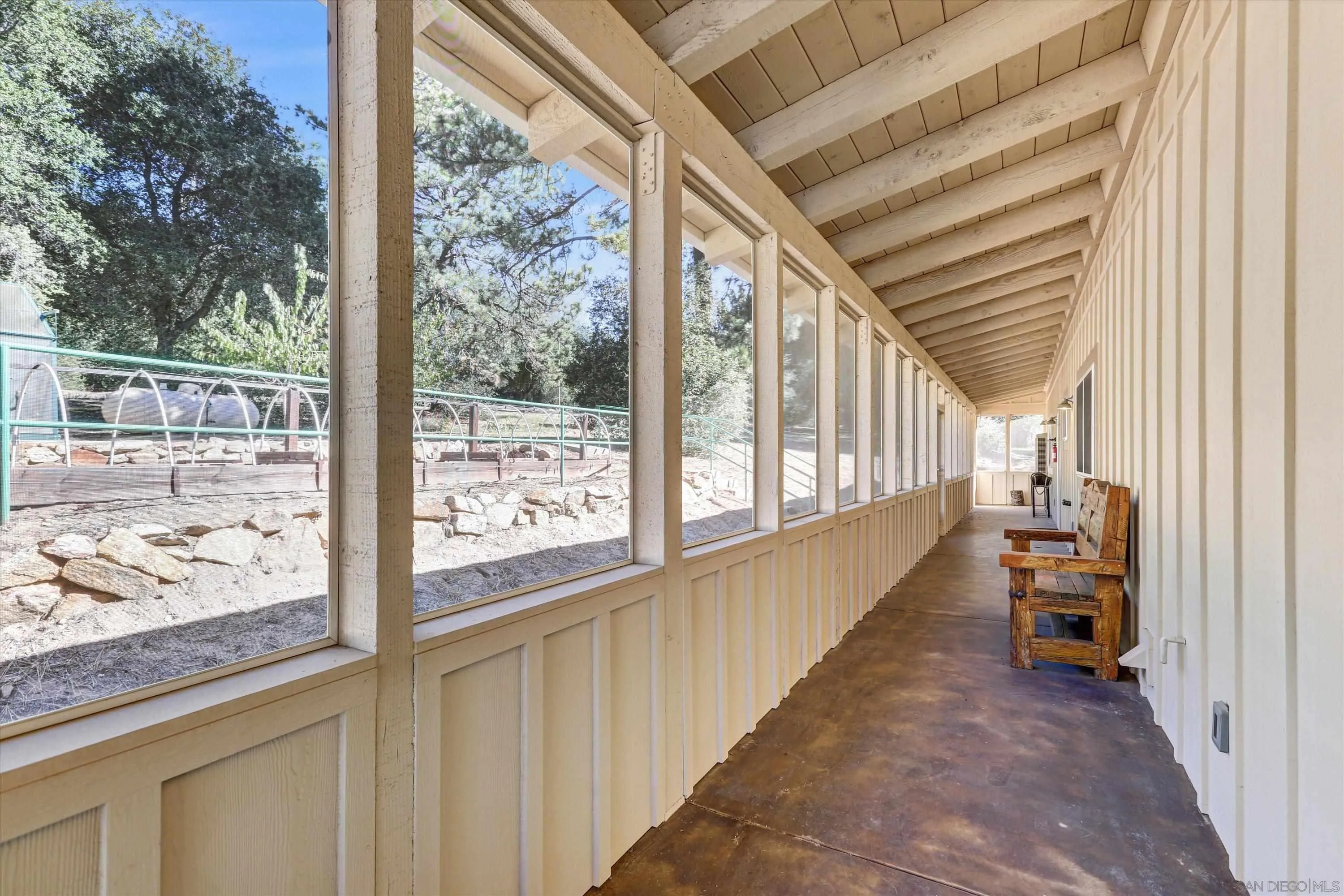 3258 Pine Hills Road Julian, CA 92036 - Photo 17 of 72 a view of a porch with wooden floor and furniture