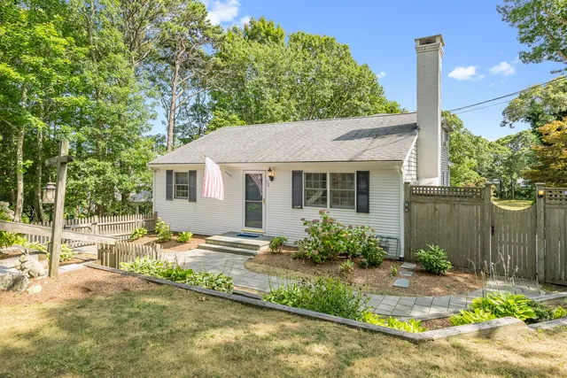 a view of a house with backyard and sitting area