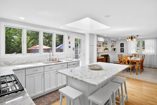a kitchen with granite countertop kitchen island stainless steel appliances a sink and counter space