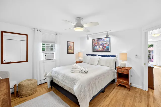 a bedroom with a bed and wooden floor