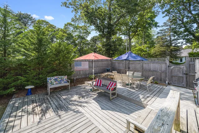 an outdoor sitting area with furniture and wooden deck