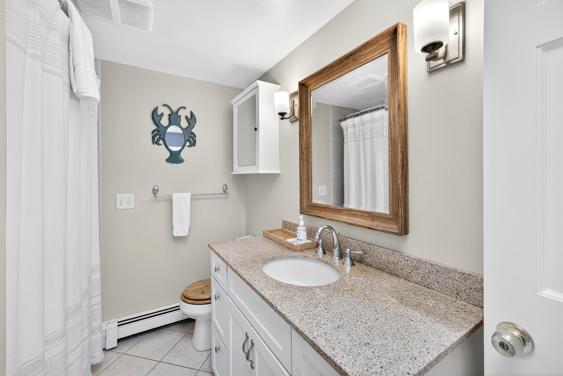 53 Great Oak Road Orleans, MA 02653 - Photo 23 of 53 a bathroom with a granite countertop sink and a mirror