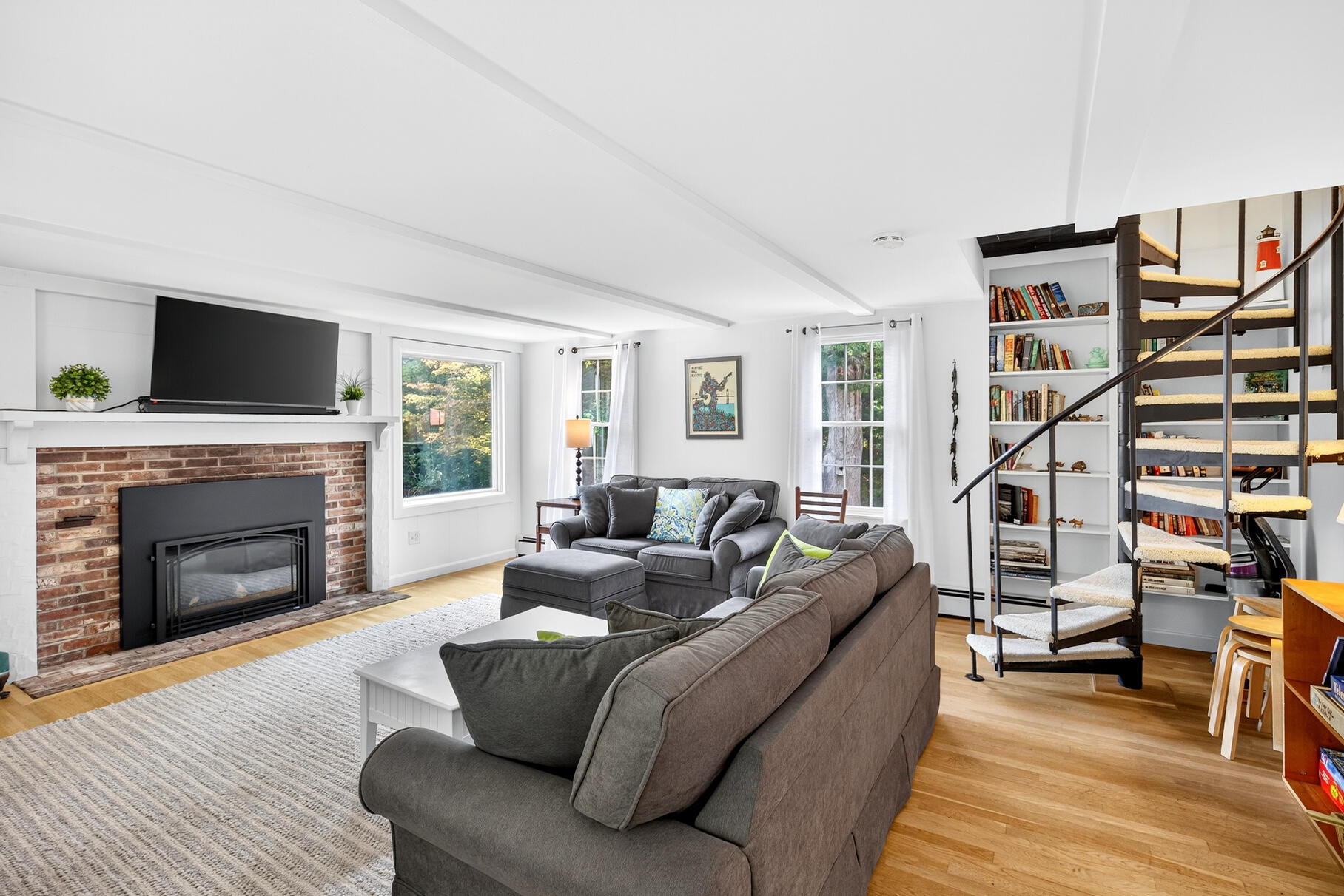53 Great Oak Road Orleans, MA 02653 - Photo 25 of 53 a living room with furniture a fireplace and a flat screen tv