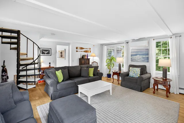 a living room with furniture a fireplace and a window