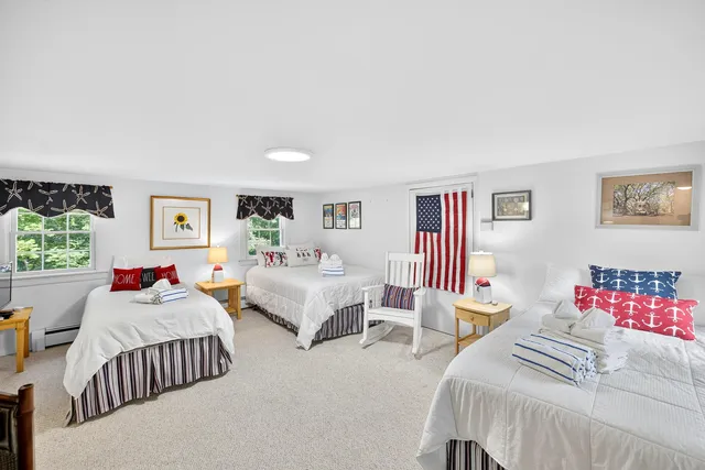 a bedroom with two beds and a dresser