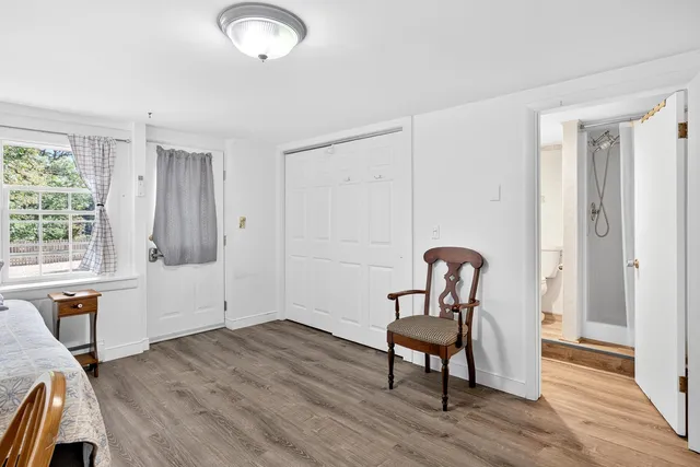 a view of a workspace with furniture and wooden floor