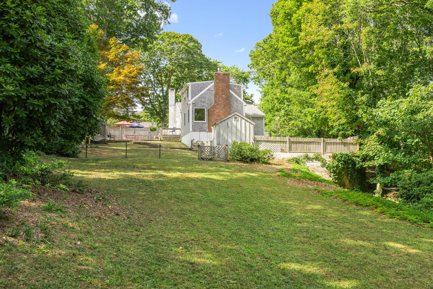 53 Great Oak Road Orleans, MA 02653 - Photo 45 of 53 a view of backyard with swimming pool and green space