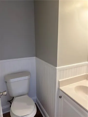 a white toilet sitting next to a bathroom sink