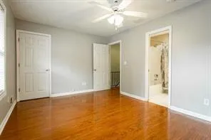 an empty room with closet and a chandelier fan