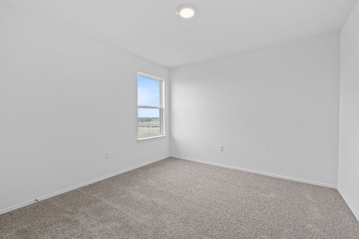 18500 B Empire Path Manor, TX 78653 - Photo 19 of 31 Carpeted empty room with baseboards