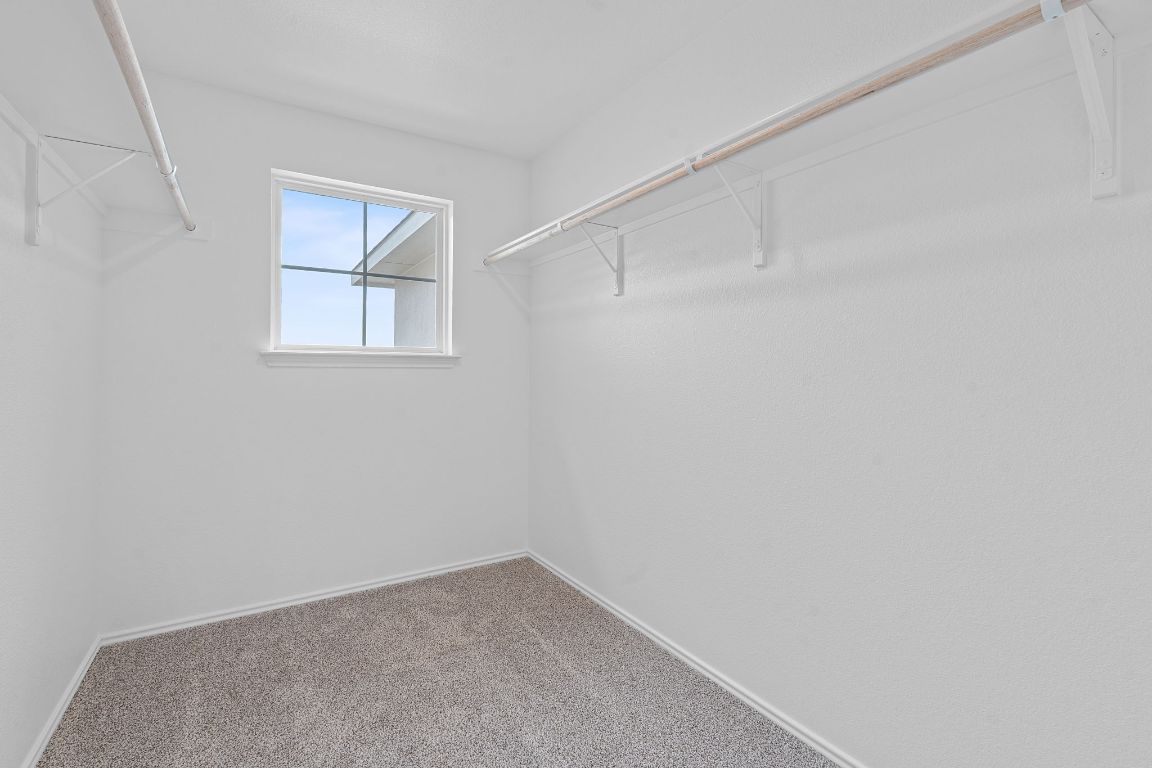 18500 B Empire Path Manor, TX 78653 - Photo 22 of 31 Walk in closet featuring carpet