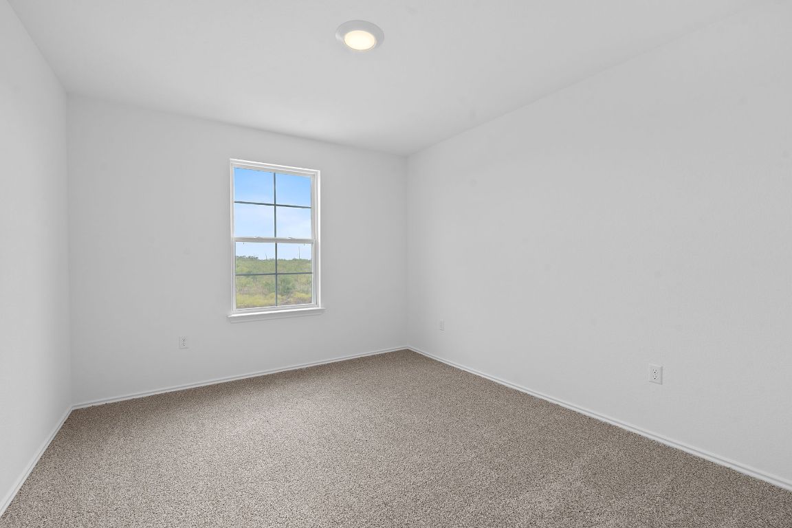 18500 B Empire Path Manor, TX 78653 - Photo 27 of 31 Carpeted empty room with baseboards