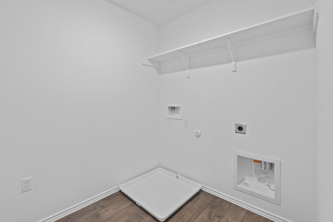 18500 B Empire Path Manor, TX 78653 - Photo 30 of 31 Washroom featuring hookup for a gas dryer, dark wood-style flooring, electric dryer hookup, and washer hookup