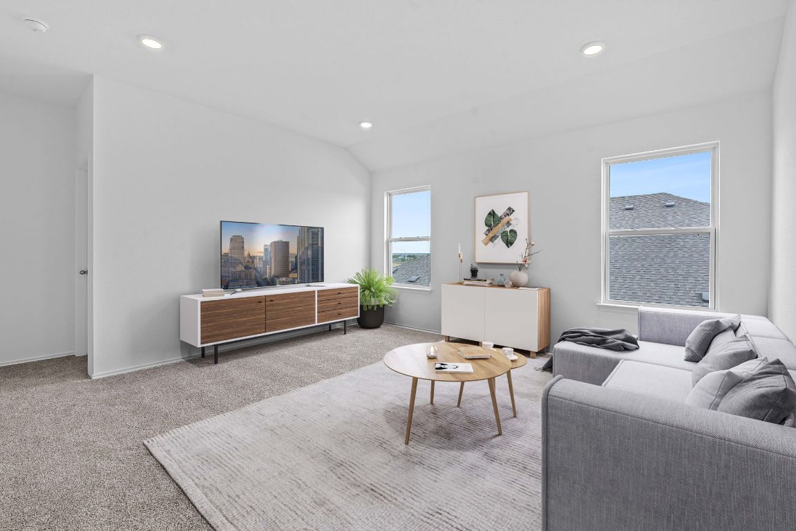 18500 B Empire Path Manor, TX 78653 - Photo 3 of 31 Living area featuring carpet floors, recessed lighting, and lofted ceiling