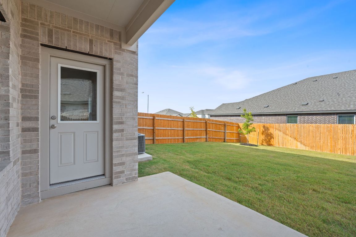 18500 B Empire Path Manor, TX 78653 - Photo 31 of 31 Fenced backyard with a patio area