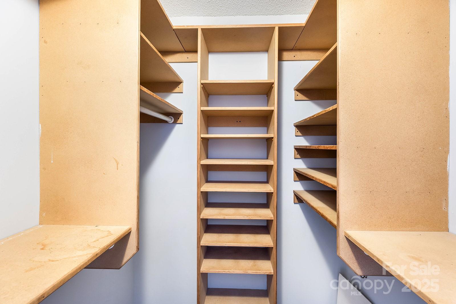 11015 Harrowfield Road Charlotte, NC 28226 - Photo 12 of 28 a view of walk in closet with empty racks