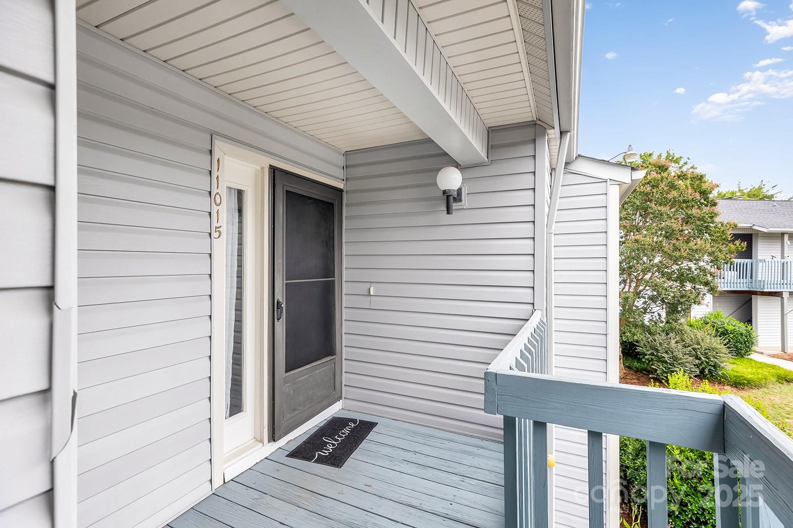 11015 Harrowfield Road Charlotte, NC 28226 - Photo 22 of 28 a view of a balcony with a door and wooden floor
