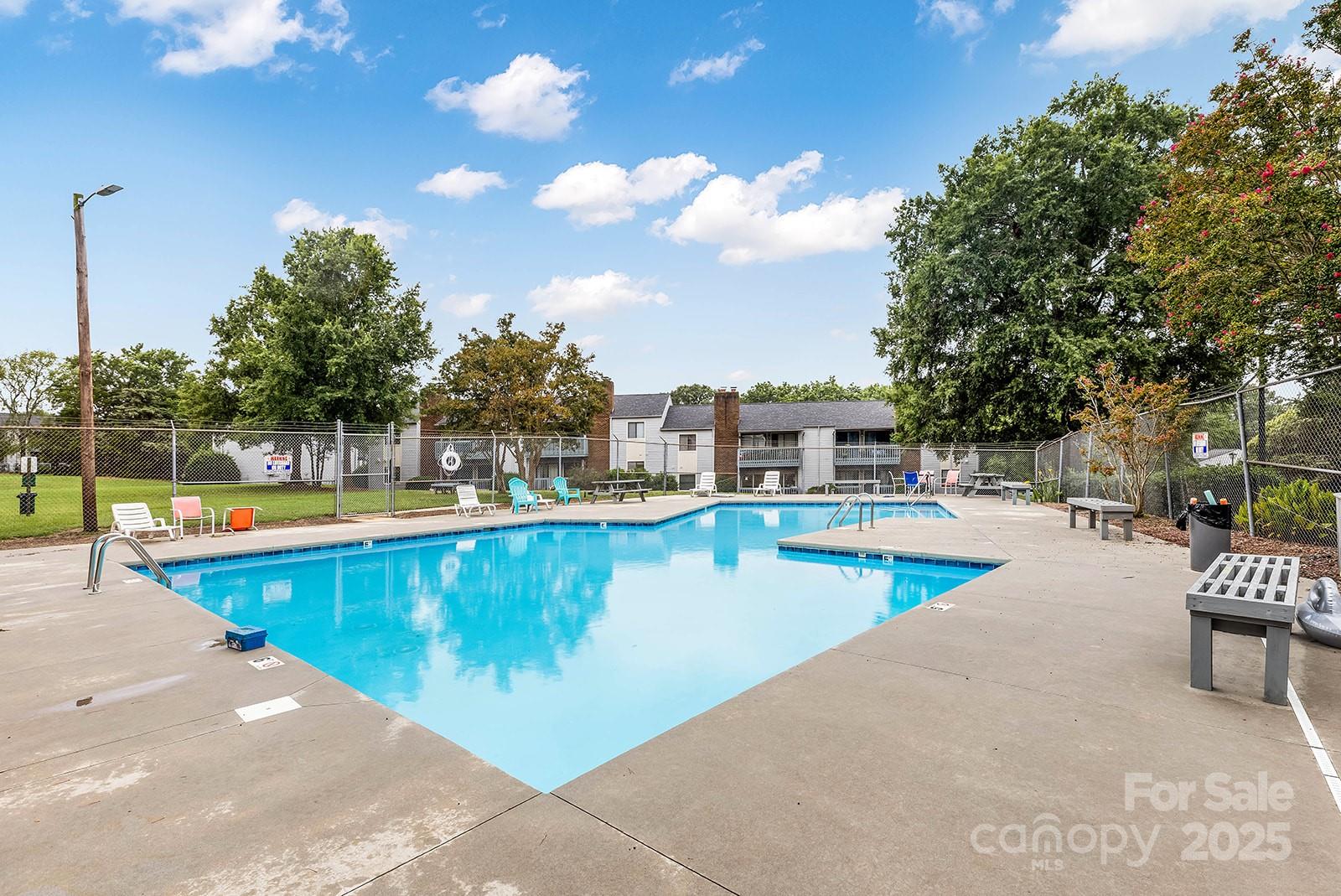 11015 Harrowfield Road Charlotte, NC 28226 - Photo 25 of 28 a view of a swimming pool with a lounge chair