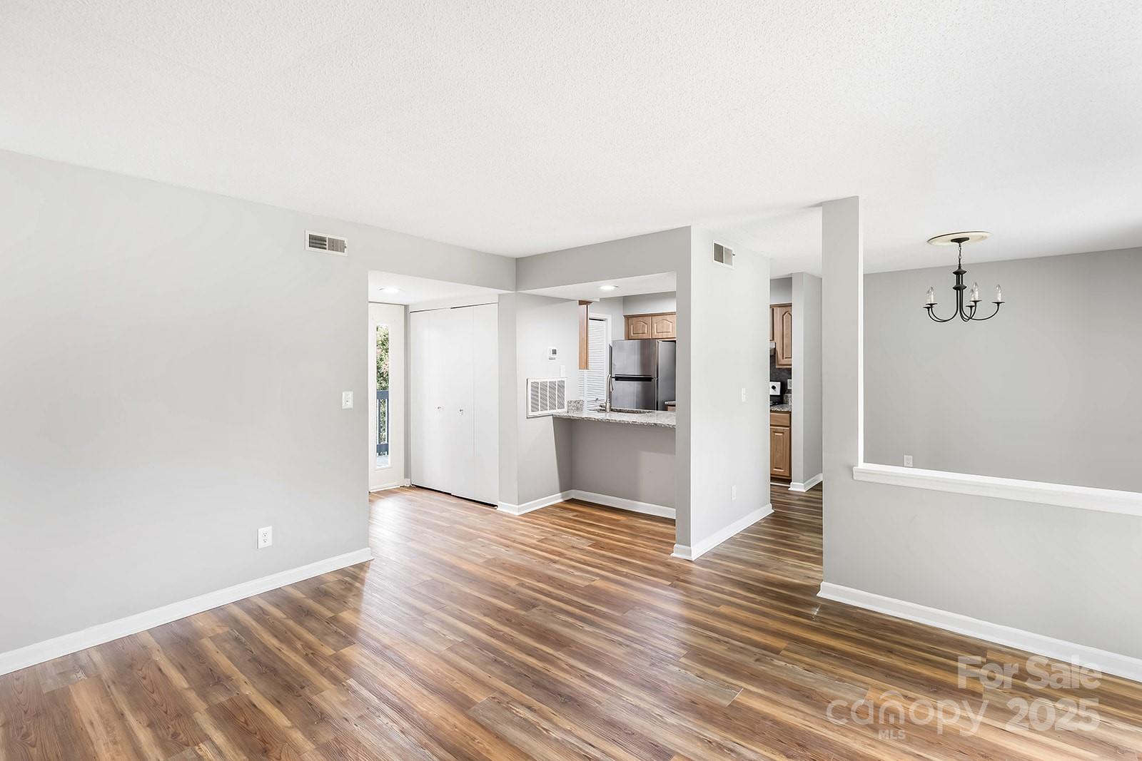 11015 Harrowfield Road Charlotte, NC 28226 - Photo 7 of 28 a view of a kitchen with wooden floor and a sink