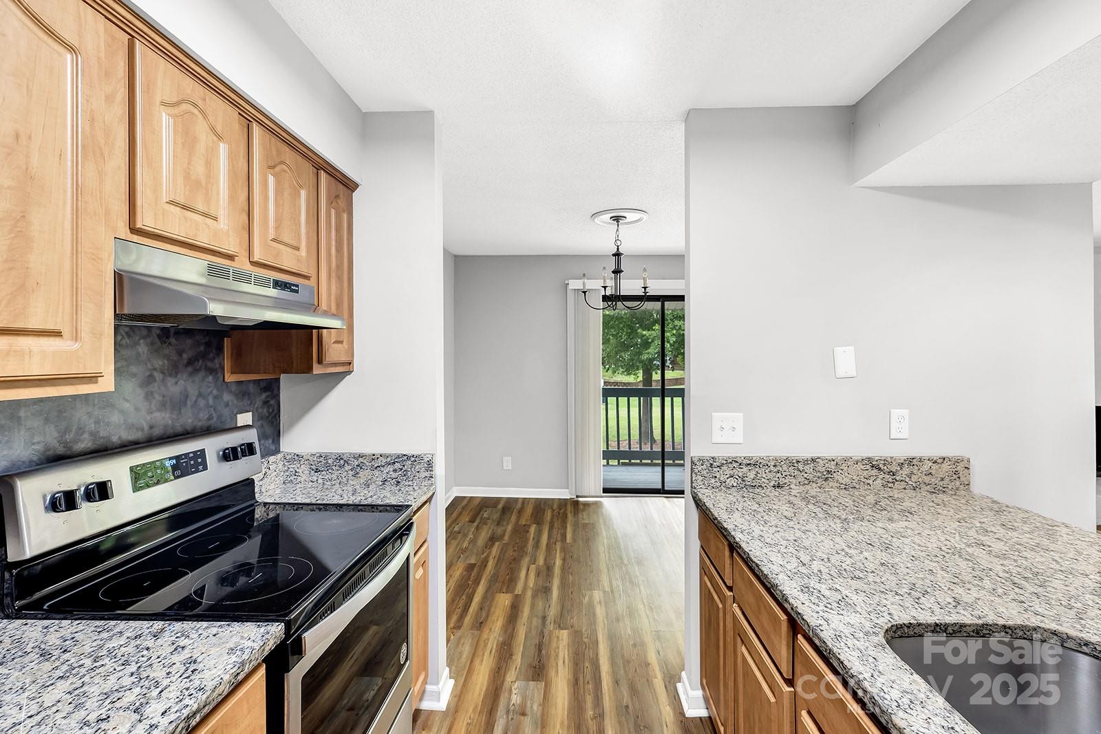 11015 Harrowfield Road Charlotte, NC 28226 - Photo 9 of 28 a kitchen with granite countertop a stove and a sink