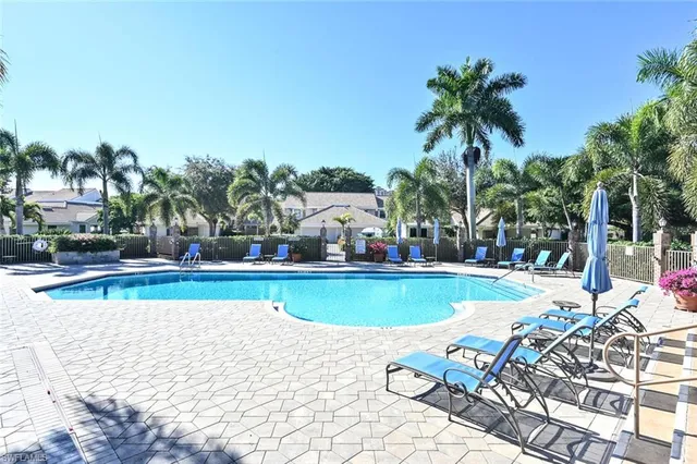 a view of a swimming pool with an outdoor seating