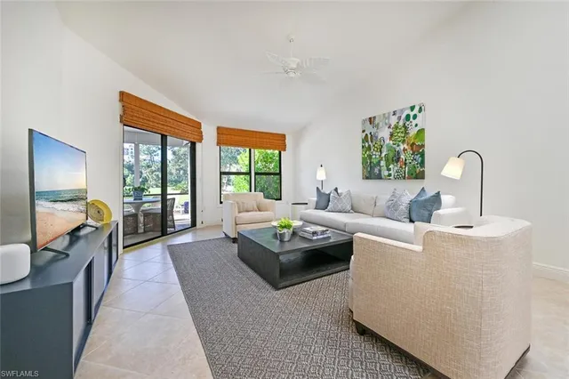 a living room with furniture and a floor to ceiling window