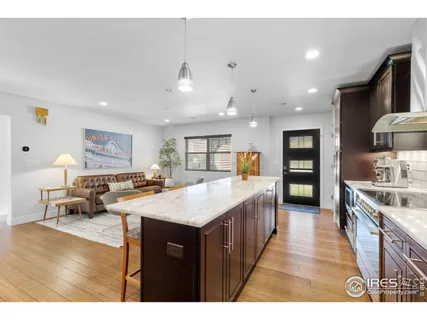 a large kitchen with a table and chairs