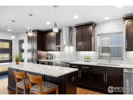 a kitchen with granite countertop a sink and cabinets