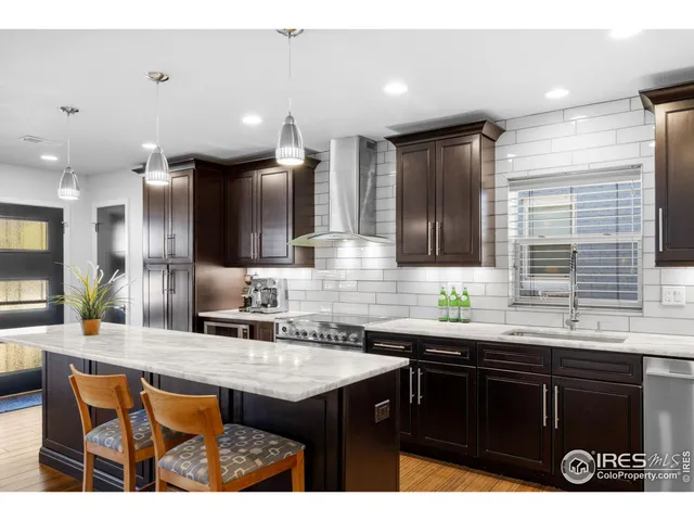 a kitchen with granite countertop a sink and cabinets