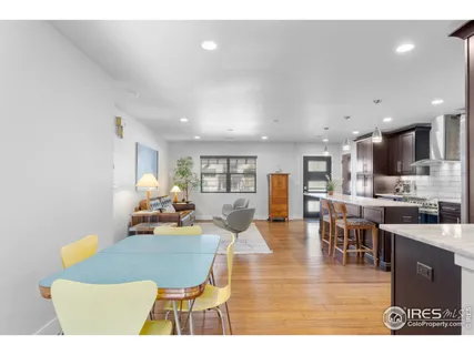 a living room with stainless steel appliances kitchen island granite countertop furniture and a view of kitchen