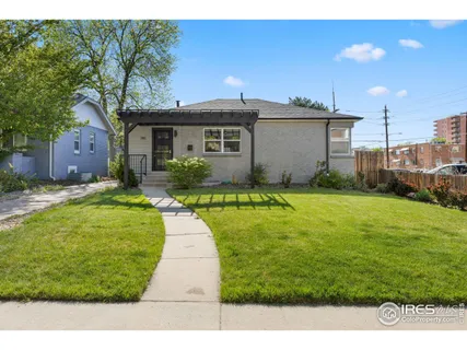 a front view of a house with yard and green space