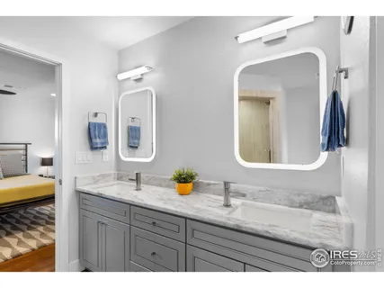 a bathroom with a double vanity sink and a mirror