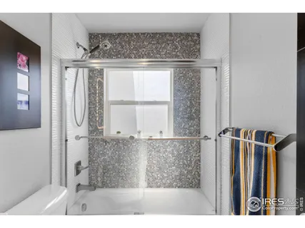 a bathroom with a shower and a mirror