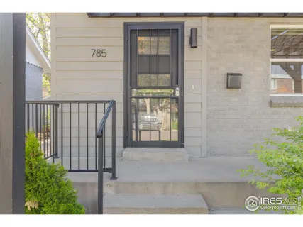 a view of entryway with a floor to ceiling window and wooden floor