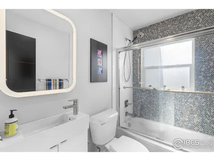 a bathroom with a bathtub a sink and a shower