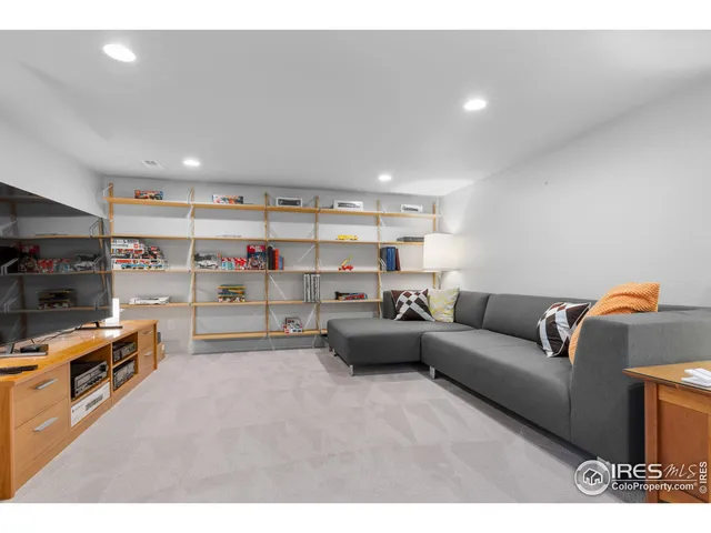 a living room with furniture and a kitchen view