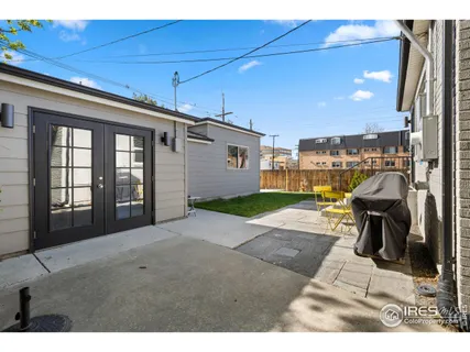 a view of a patio with a table and chairs