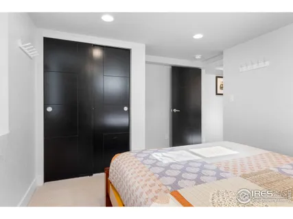 a bedroom with a bed and a mirror