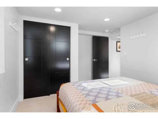 a bedroom with a bed and a mirror