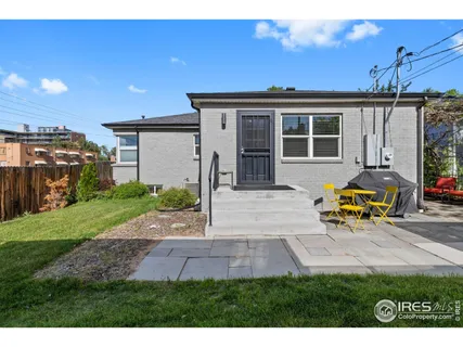 a view of a house with backyard and sitting area