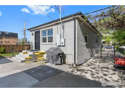 a view of a house with backyard and furniture