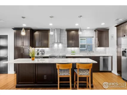 a kitchen with stainless steel appliances granite countertop a sink and cabinets