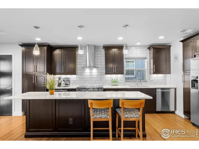 a kitchen with stainless steel appliances granite countertop a sink and cabinets