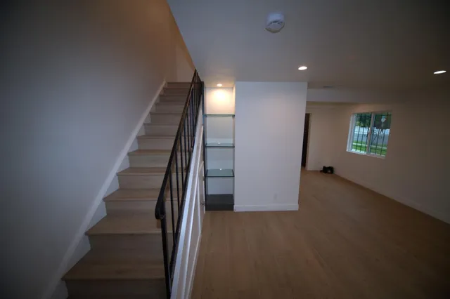 a view of entryway and hall with wooden floor