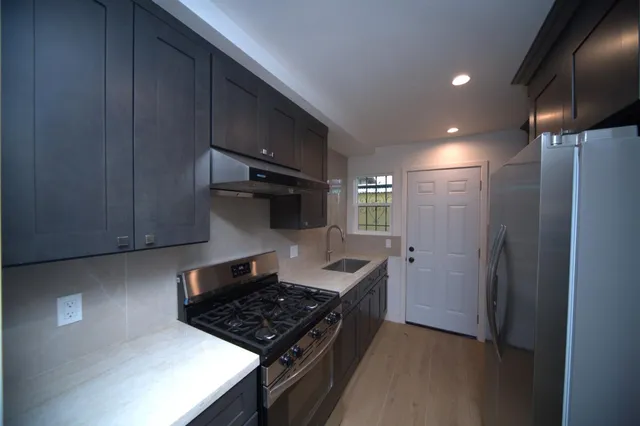 a kitchen with a stove and a refrigerator