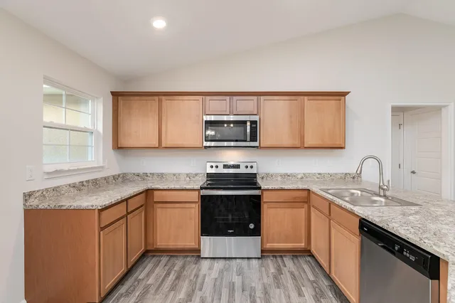 a kitchen with a sink cabinets and window