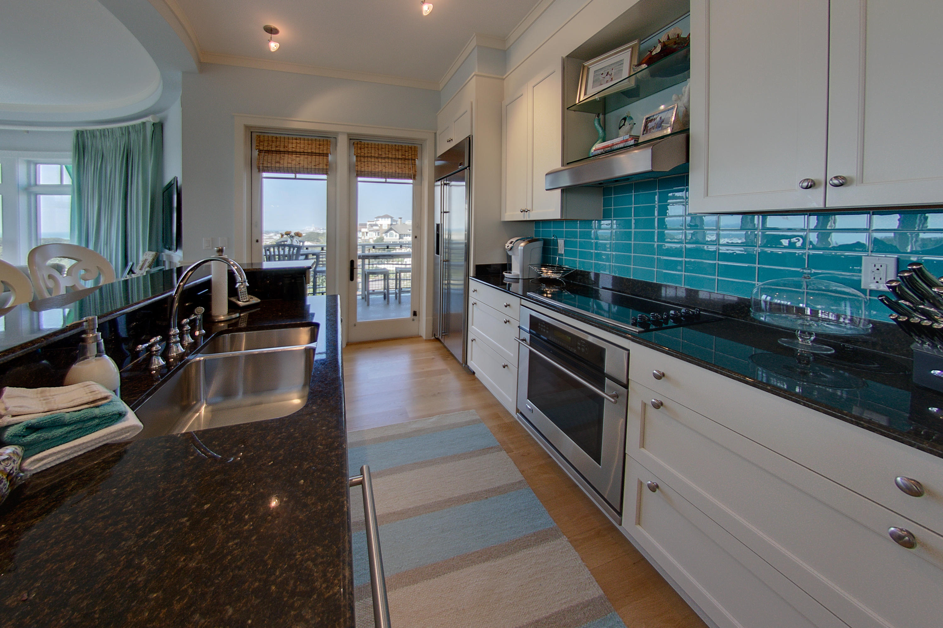 99 Compass Point Way Inlet Beach, Unit 308 Inlet Beach, FL 32461 - Photo 13 of 55 a kitchen with stainless steel appliances granite countertop a stove a sink and a refrigerator
