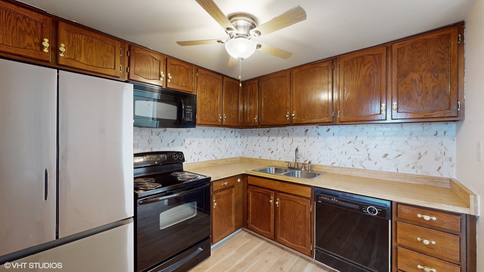 2005 South Finley Road, Unit 805 Lombard, IL 60148 - Photo 12 of 34 a kitchen with a sink a stove and cabinets